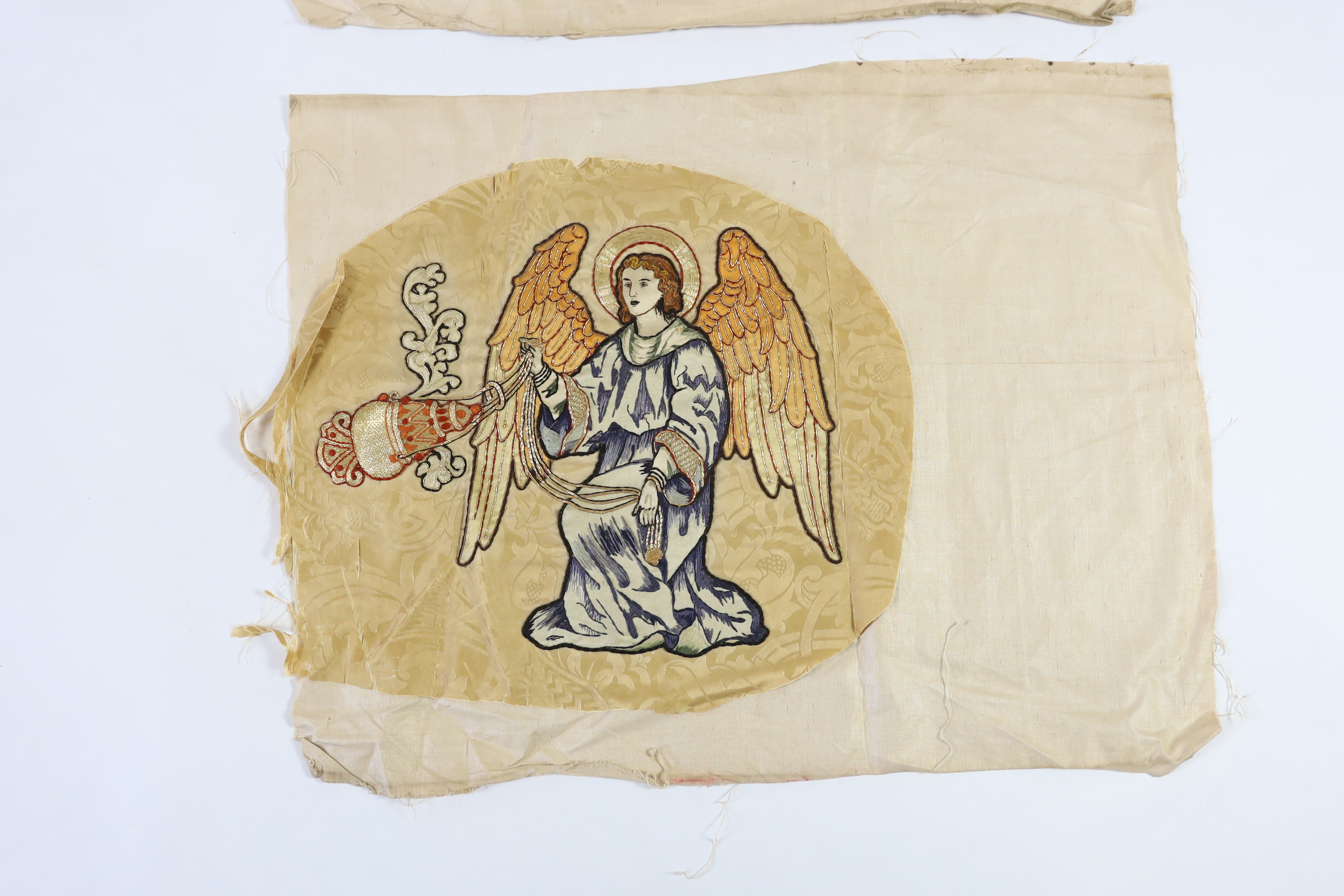 Two 1880-90’s angelic embroideries, appliquéd onto silk damask, originally from an alter frontal, the appliqués being silk embroidered with gold thread highlights of angels with thurible to cleanse with incense, appliqué